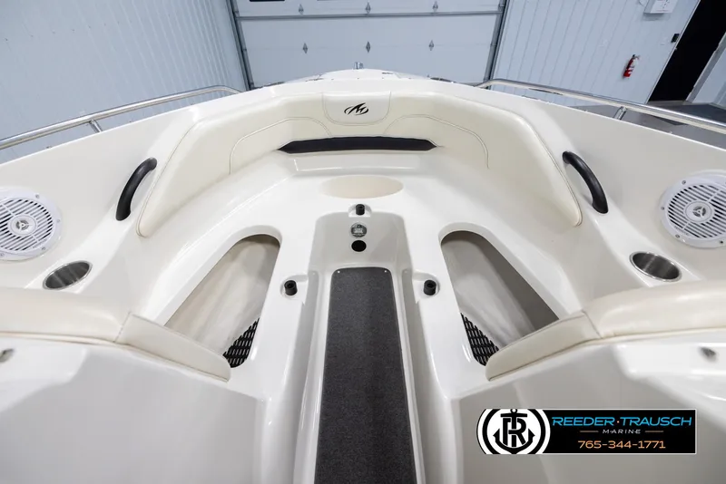 Slide: The Image of 2007 Monterey 234 FS boat interior with seating and speakers in a showroom. - 17