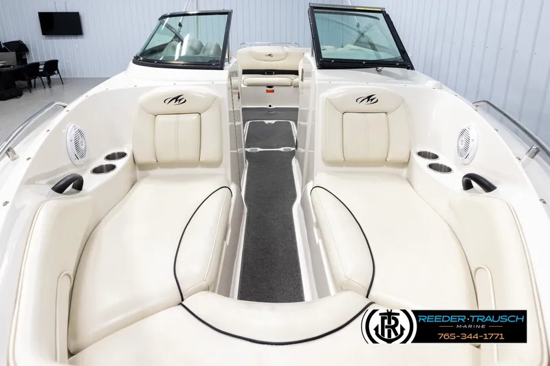 Slide: The Image of 2007 Monterey 234 FS boat interior with white seating and black accents. - 18