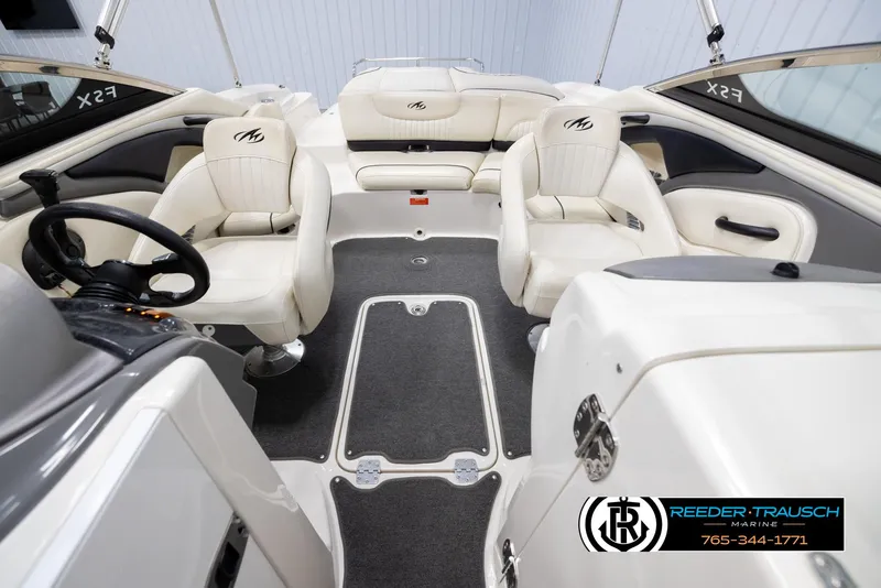 Slide: The Image of 2007 Monterey 234 FS boat interior with white seating and steering wheel. - 19
