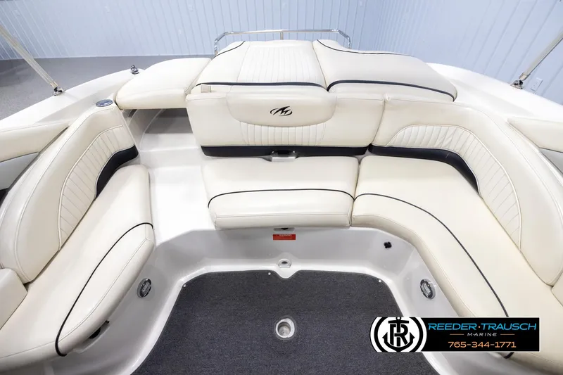 Slide: The Image of 2007 Monterey 234 FS boat interior with white leather seating and logo. - 21