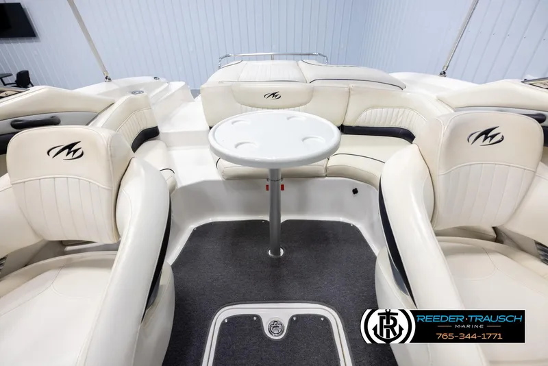 Slide: The Image of 2007 Monterey 234 FS boat interior with white seating and round table. - 23
