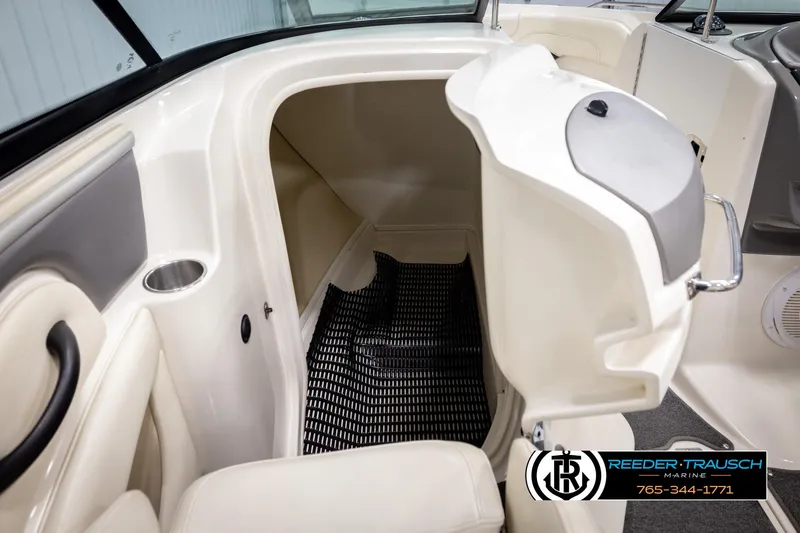 Slide: The Image of 2007 Monterey 234 FS boat interior with open storage compartment and seating. - 24