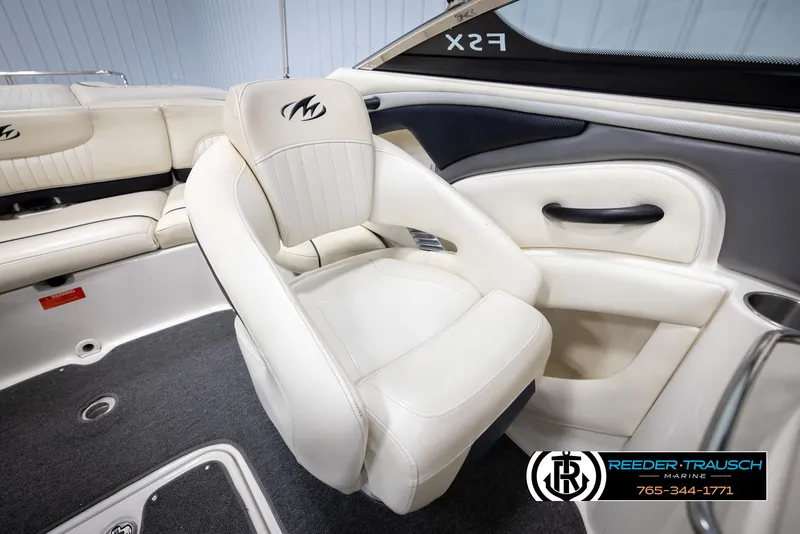 Slide: The Image of 2007 Monterey 234 FS boat interior with white seating and logo detail. - 25