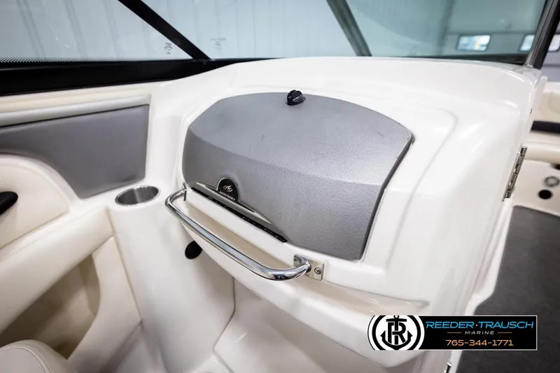 Slide: The Image of 2007 Monterey 234 FS boat interior with glove compartment and cup holder. - 27