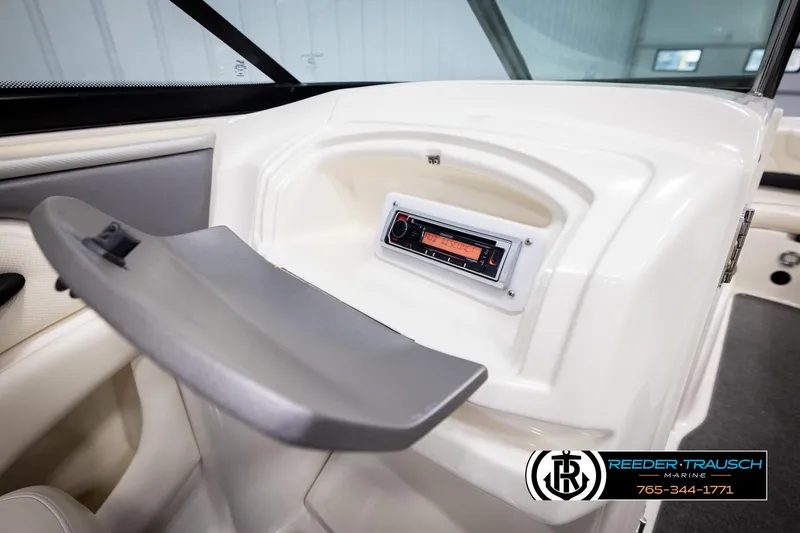 Slide: The Image of 2007 Monterey 234 FS boat interior with stereo system and storage compartment. - 28