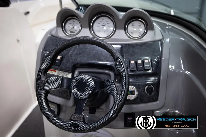Slide: The Image of Steering wheel and dashboard of 2007 Monterey 234 FS boat with gauges and controls. - 30