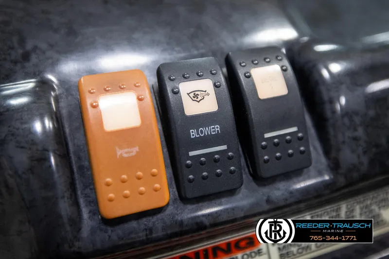 Slide: The Image of Dashboard switches of a 2007 Monterey 234 FS boat, featuring blower and accessory controls. - 33