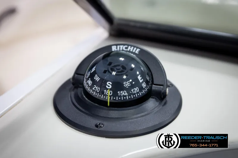Slide: The Image of Ritchie compass on 2007 Monterey 234 FS boat dashboard, featuring Reeder-Trausch Marine logo. - 34