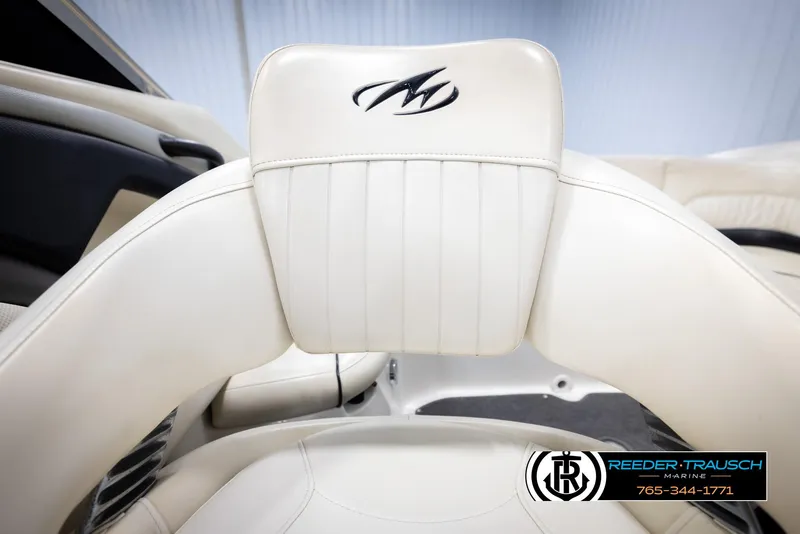 Slide: The Image of 2007 Monterey 234 FS boat interior with white leather seating and logo detailing. - 40