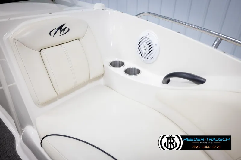 Slide: The Image of 2007 Monterey 234 FS boat interior with white seating, cup holders, and speaker. - 42