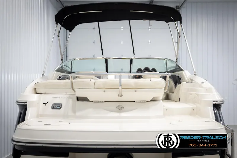 Slide: The Image of 2007 Monterey 234 FS boat with black canopy in storage unit. - 7