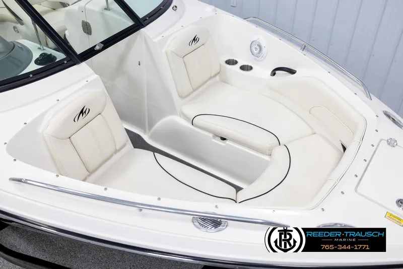 Slide: The Image of 2007 Monterey 234 FS boat interior with white seating and cup holders. - 9