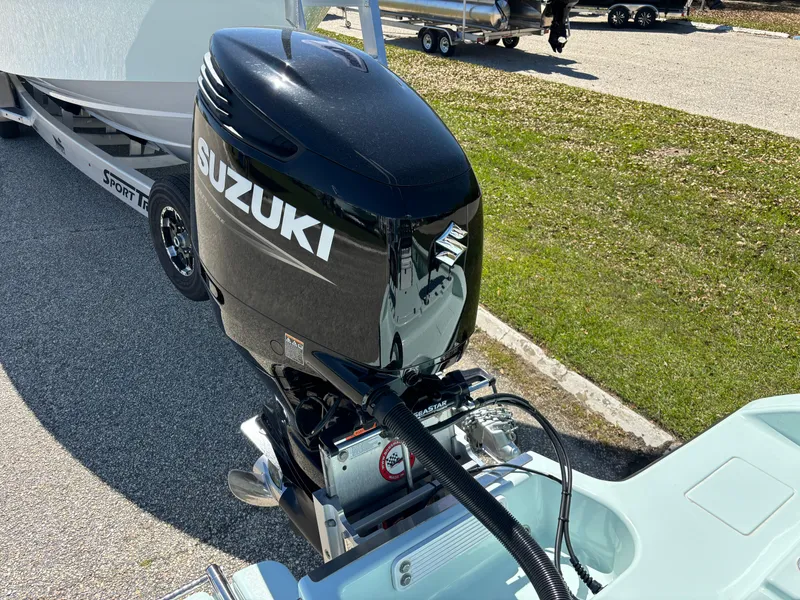 Slide: The Image of Outboard motor on a 2024 Clark Sound 24 boat, parked on a trailer. - 17