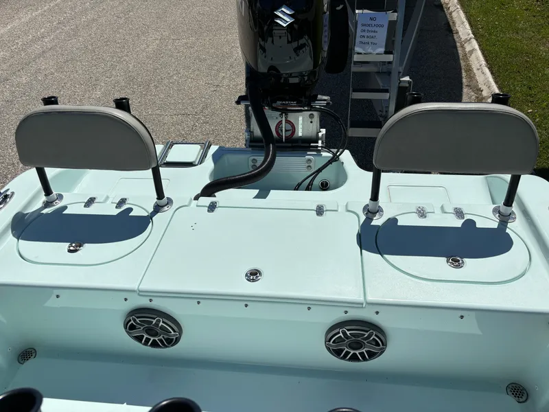 Slide: The Image of 2024 Clark Sound 24 boat with dual seats and motor, featuring built-in speakers. - 20