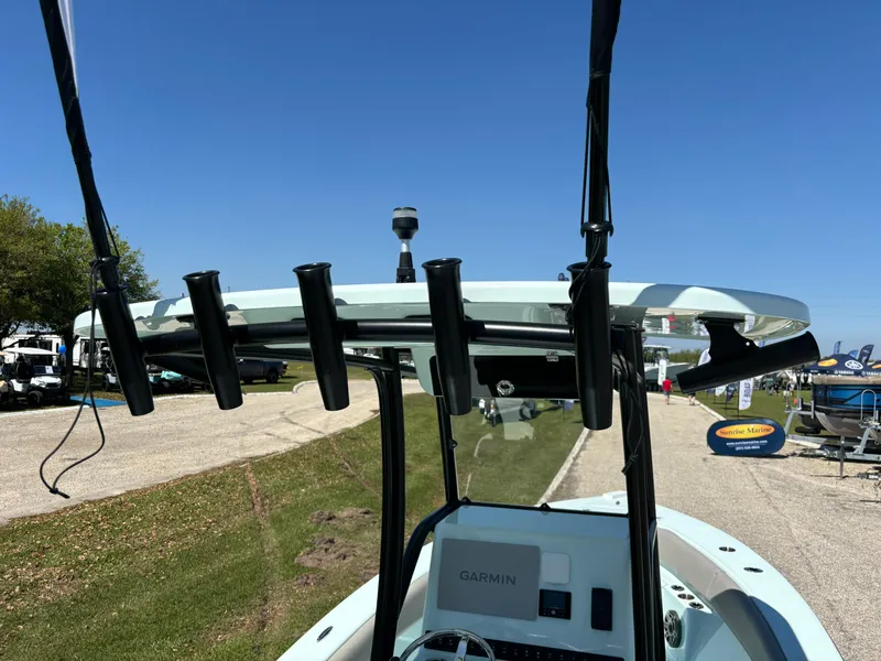 Slide: The Image of 2024 Clark Sound 24 boat with rod holders and Garmin equipment, displayed outdoors. - 22