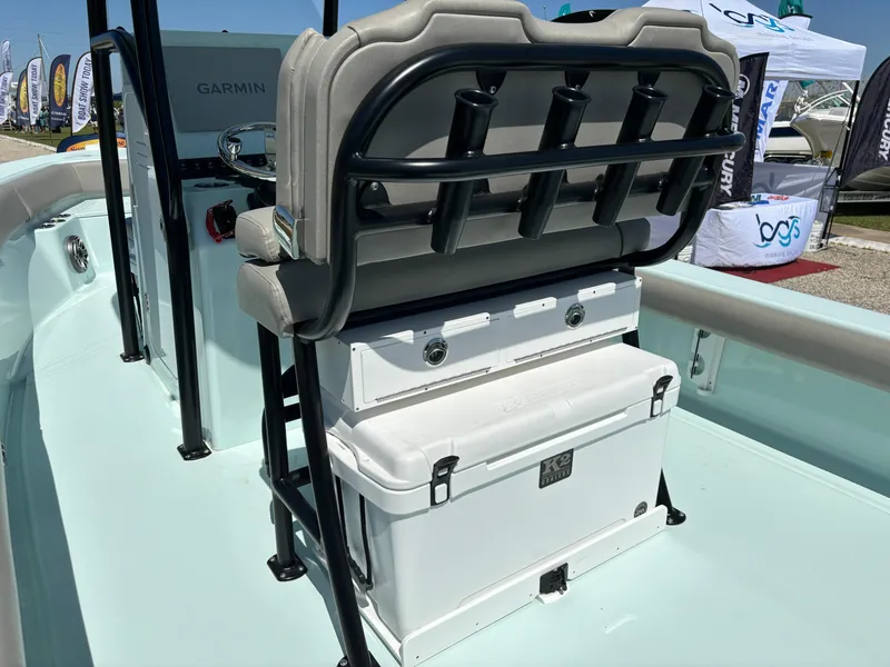 Slide: The Image of 2024 Clark Sound 24 boat interior with seating and storage, featuring a Garmin system. - 24