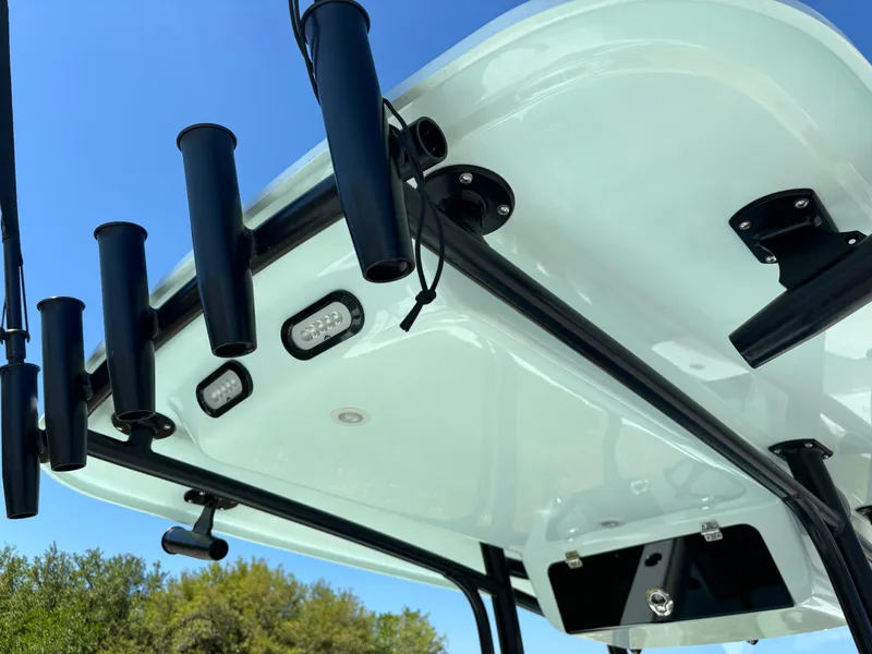 Slide: The Image of 2024 Clark Sound 24 boat with rod holders and LED lights under a clear blue sky. - 31