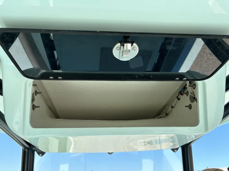 Slide: The Image of Open storage compartment on a 2024 Clark Sound 24 boat, featuring a secure latch. - 35