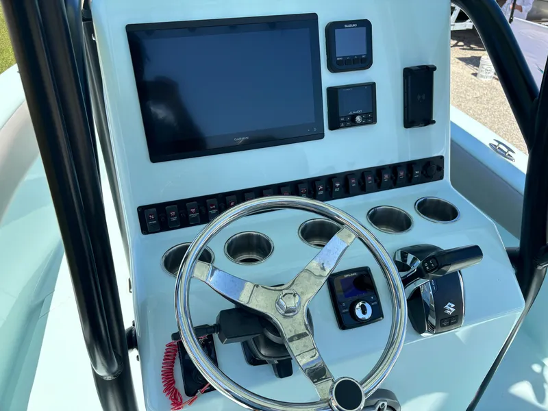 Slide: The Image of Control panel of 2024 Clark Sound 24 boat with steering wheel and electronic displays. - 37