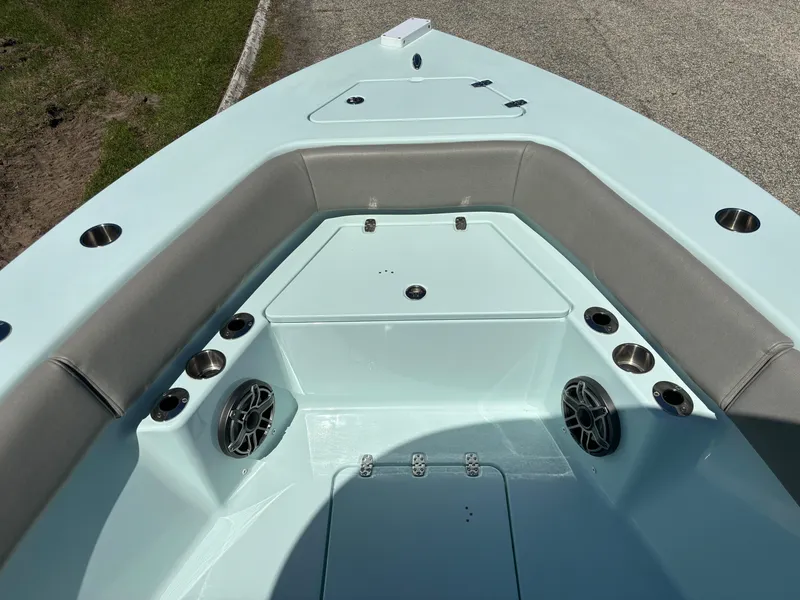 Slide: The Image of 2024 Clark Sound 24 boat interior with cushioned seating and built-in speakers. - 40