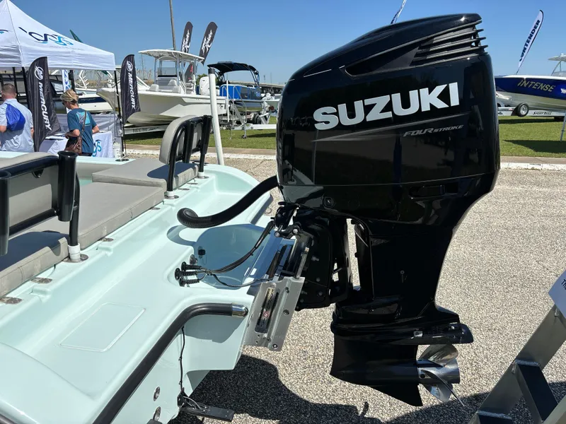 Slide: The Image of 2024 Clark Sound 24 boat with Suzuki outboard motor at a boat show. - 5