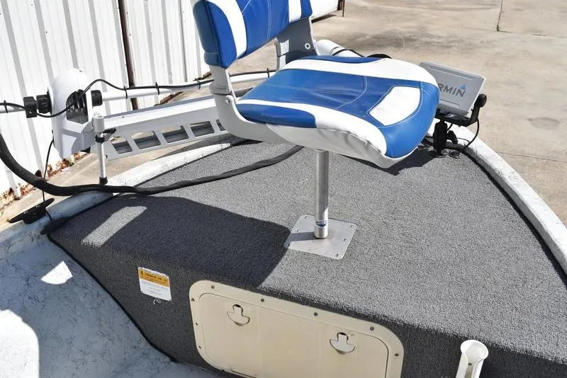 Slide: The Image of 1996 Kenner 16v boat with blue and white seat, carpeted deck, and mounted equipment. - 12