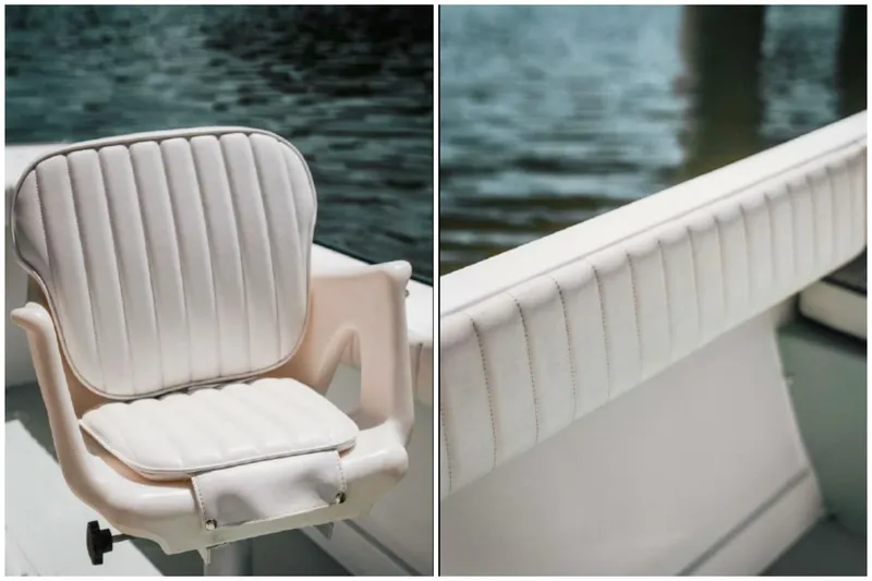 Slide: The Image of 1976 Aquasport 24 Launch boat interior with white cushioned seating by the water. - 10