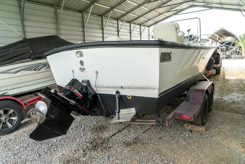 Slide: The Image of 1976 Aquasport 24 Launch boat on trailer in covered storage area. - 8