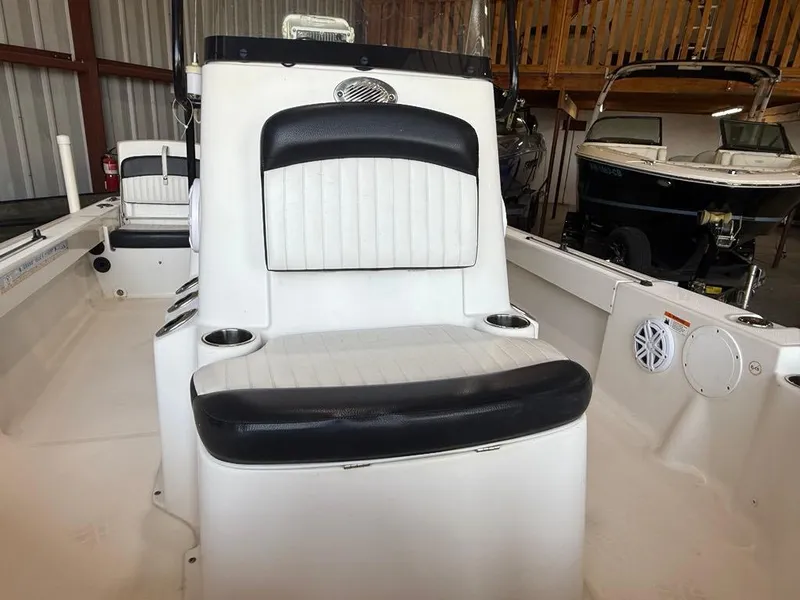 Slide: The Image of 2015 Sea Born FX22 boat interior with white and black seating in a storage area. - 12