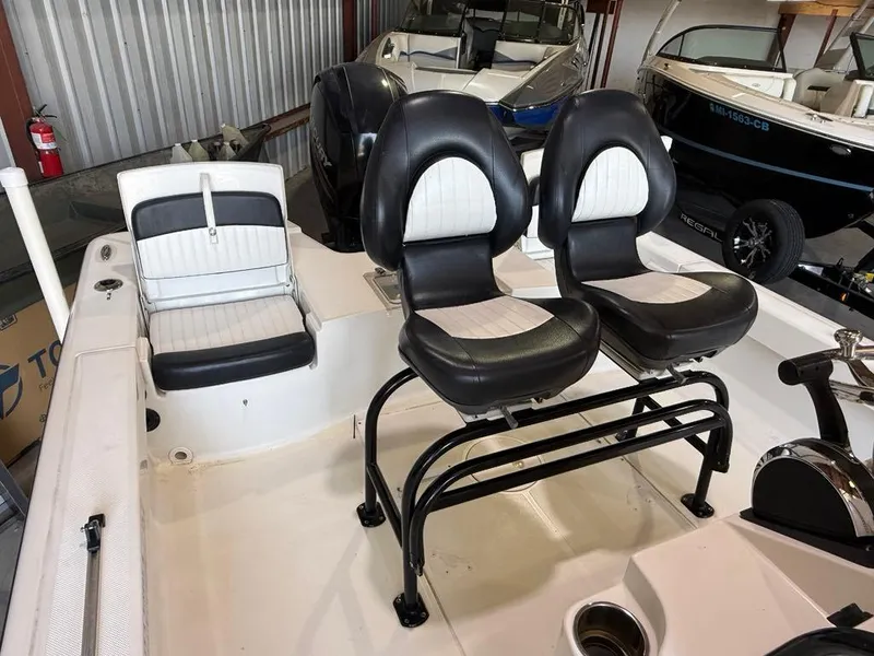 Slide: The Image of 2015 Sea Born FX22 boat interior with black and white seating in storage. - 4