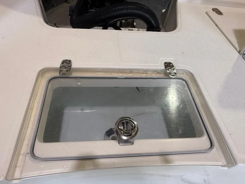 Slide: The Image of 2015 Sea Born FX22 boat compartment with transparent lid and metal hinges. - 5