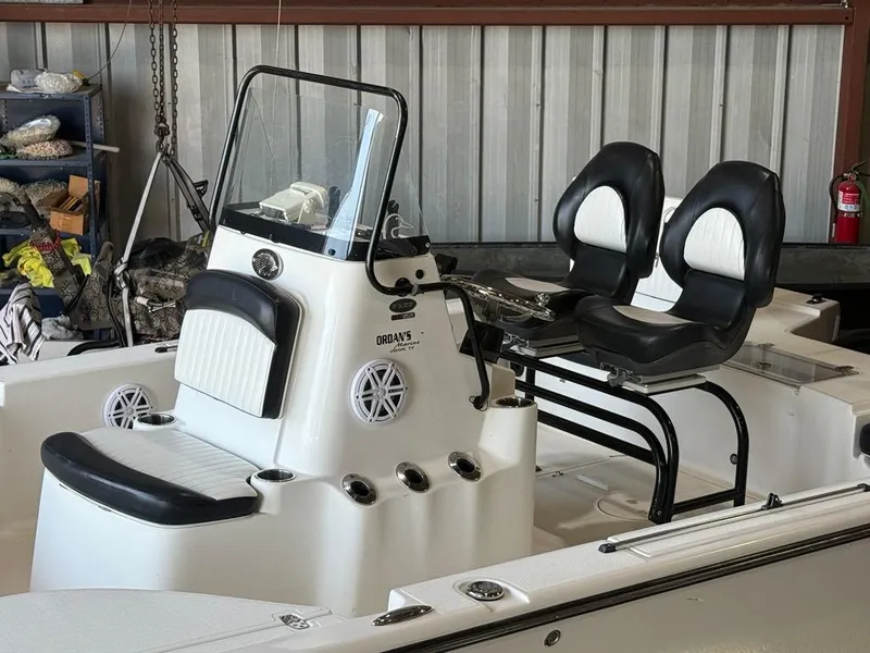 Slide: The Image of 2015 Sea Born FX22 boat interior with dual black and white seats and console. - 9