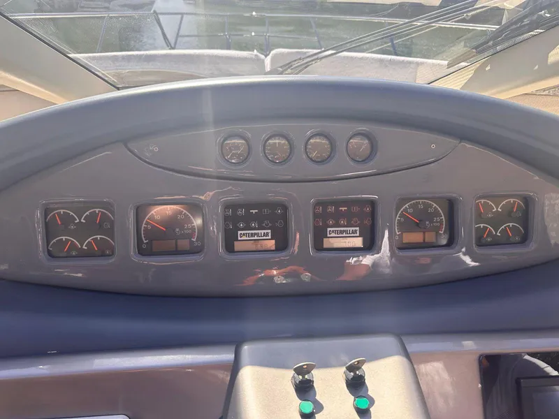 Slide: The Image of Control panel of a 2007 Azimut 55E yacht, featuring gauges and displays. - 12