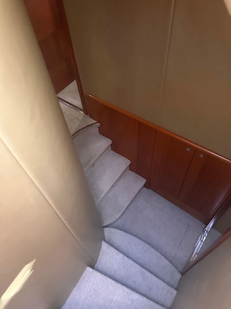 Slide: The Image of Staircase inside 2007 Azimut 55E yacht with carpeted steps and wooden paneling. - 5