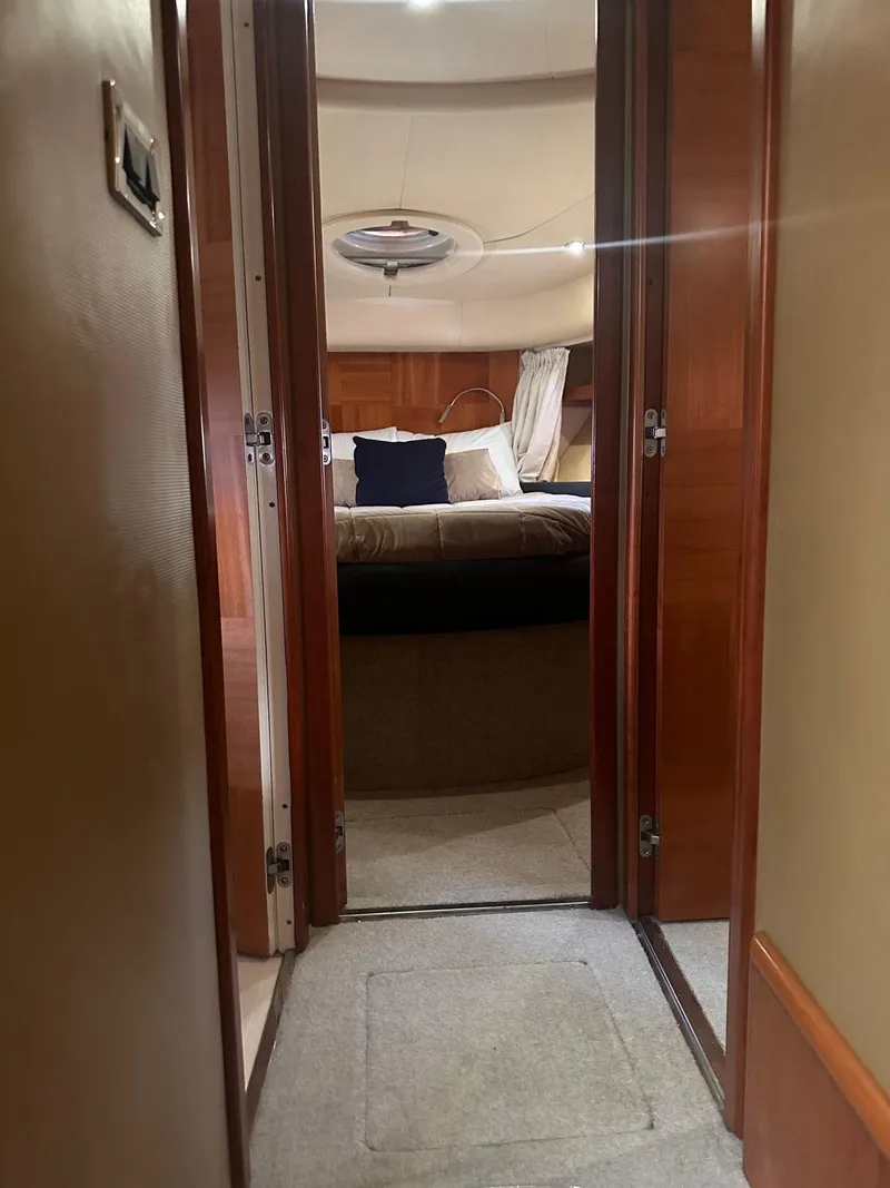 Slide: The Image of Interior view of 2007 Azimut 55E yacht cabin with bed and wooden finishes. - 6