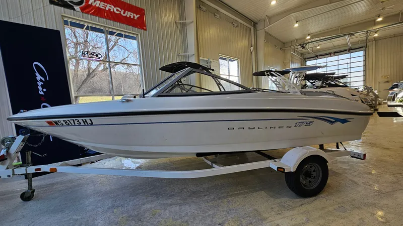 The Image of 2007 Bayliner 175 Bowrider boat on trailer in indoor showroom. - 1