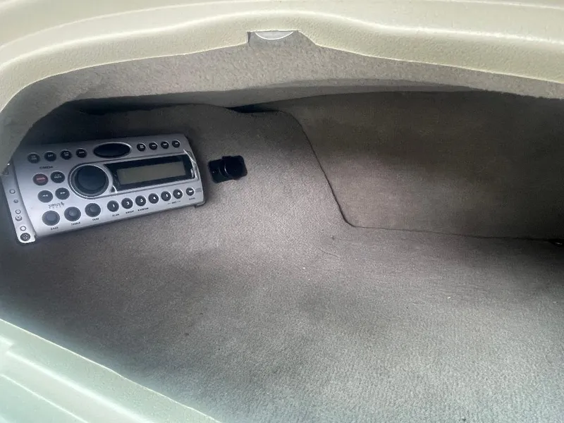 Slide: The Image of Storage compartment with stereo system in 2007 Sea Ray 210 Select boat. - 3