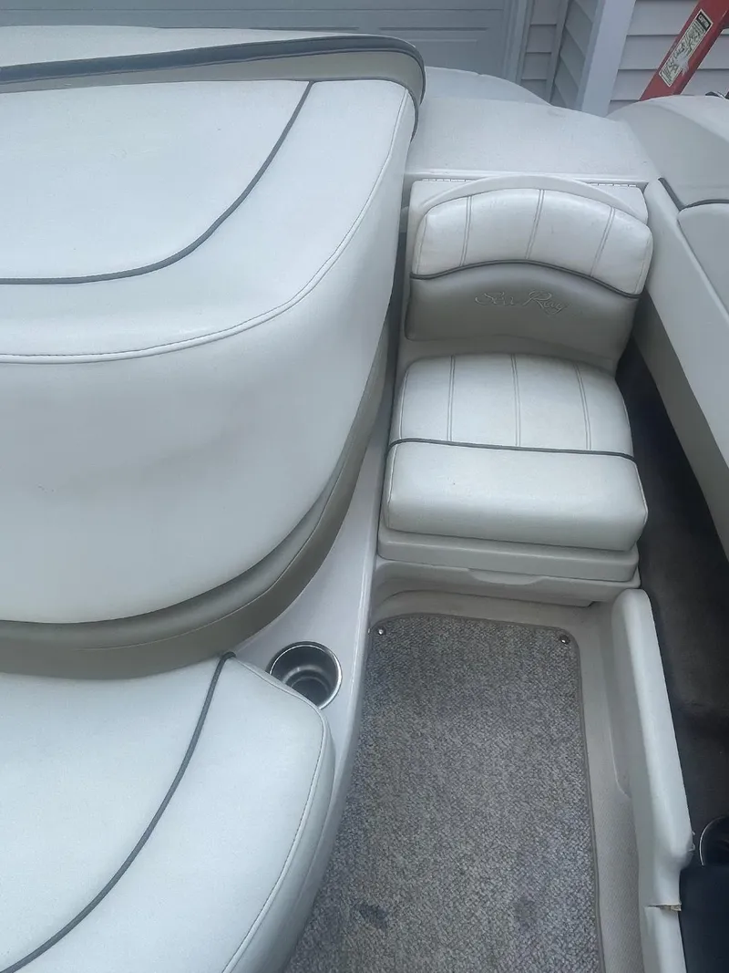 Slide: The Image of 2007 Sea Ray 210 Select boat interior with white leather seating and cup holder. - 6