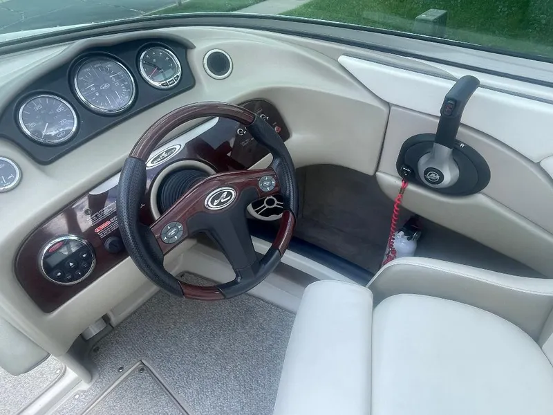 Slide: The Image of 2007 Sea Ray 210 Select boat dashboard with steering wheel and control panel. - 8