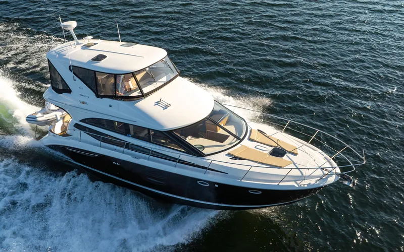 Slide: The Image of 2015 Meridian 441 Sedan yacht cruising on open water, showcasing sleek design and luxury features. - 0