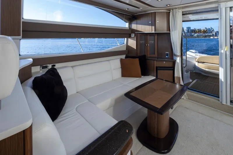 Slide: The Image of Luxurious interior of 2015 Meridian 441 Sedan yacht with white seating and wooden accents. - 12