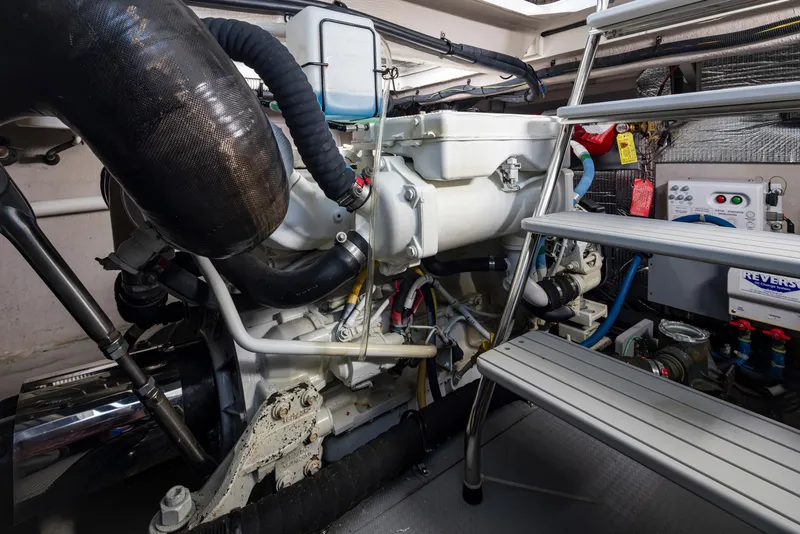 Slide: The Image of Engine room of 2015 Meridian 441 Sedan yacht, featuring mechanical components and access ladder. - 44