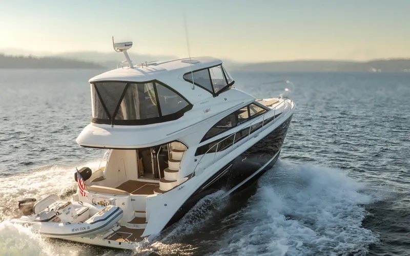 Slide: The Image of 2015 Meridian 441 Sedan yacht cruising on open water at sunset. - 48