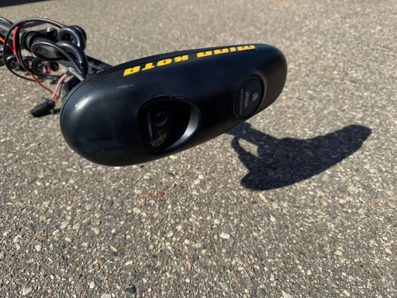 Slide: The Image of Minn Kota trolling motor on pavement, cables visible, 1979 Lund L model. - 3