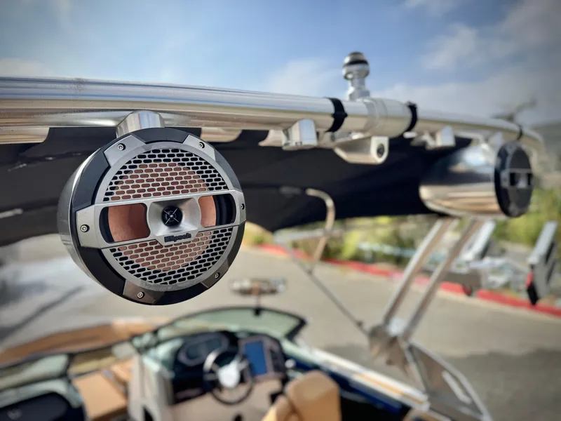 Slide: The Image of 2022 MasterCraft XStar boat with mounted speakers and sleek interior design. - 15