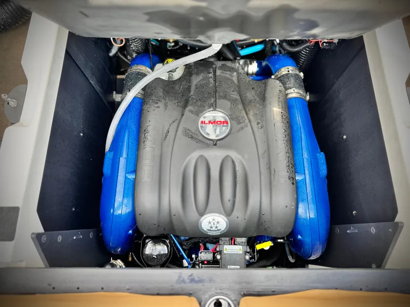 Slide: The Image of 2022 MasterCraft XStar engine compartment with Ilmor engine, featuring blue accents. - 22
