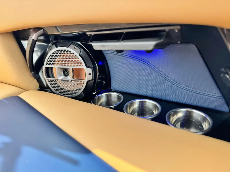 Slide: The Image of 2022 MasterCraft XStar interior with speaker and cup holders, featuring modern design elements. - 25