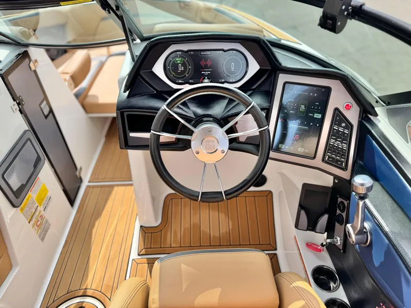 Slide: The Image of 2022 MasterCraft XStar boat cockpit with modern controls and wood finish. - 32