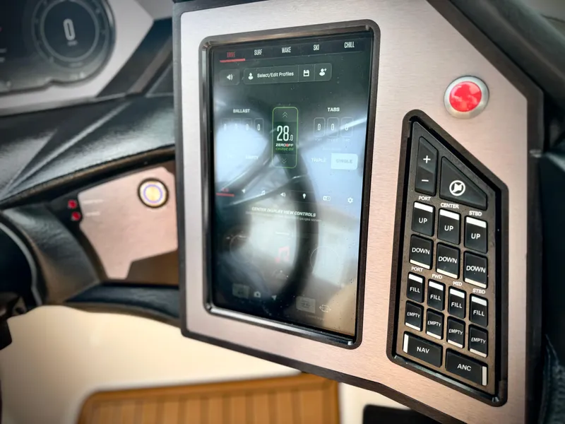 Slide: The Image of 2022 MasterCraft XStar dashboard with touchscreen and control panel. - 34