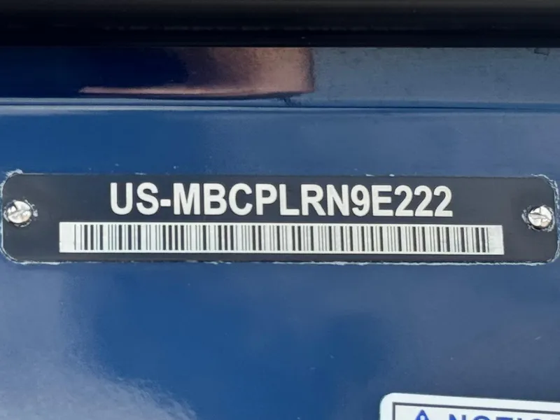 Slide: The Image of 2022 MasterCraft XStar boat identification number plate on blue surface. - 37